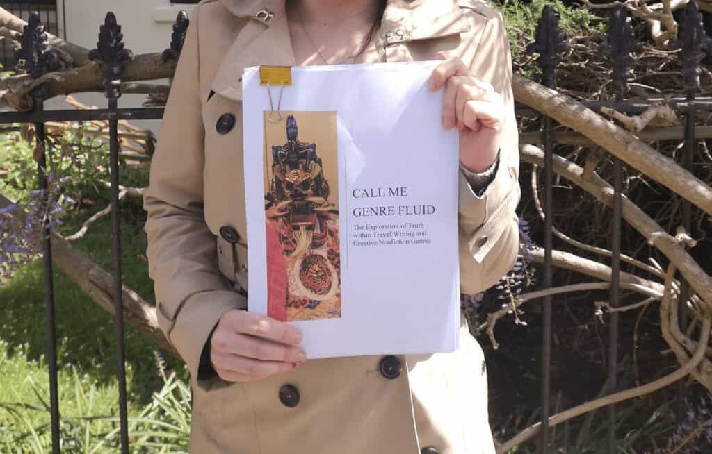 Photograph of post author, Emily Priest, holding her submitted undergraduate dissertation.