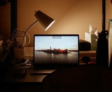 Desk space at night - computer with lamp and other desk items