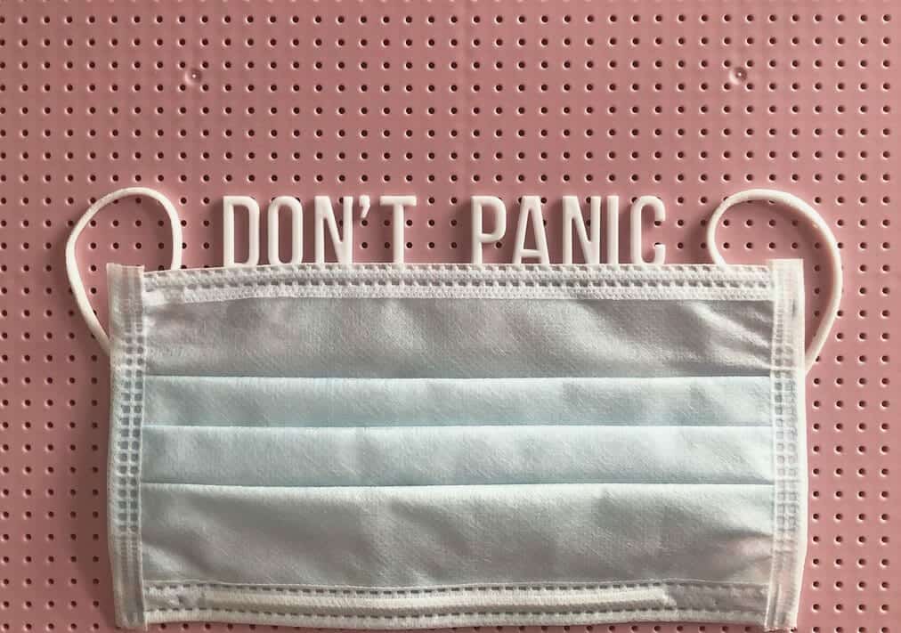 "Don't panic" alongside a white mask.