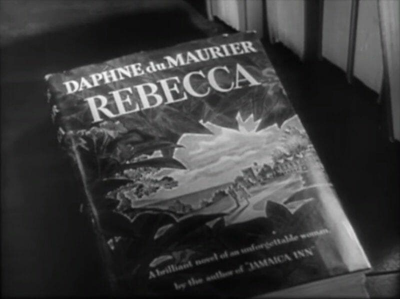 Still from the film trailer for Rebecca, featuring Daphne du Maurier’s novel of the same name