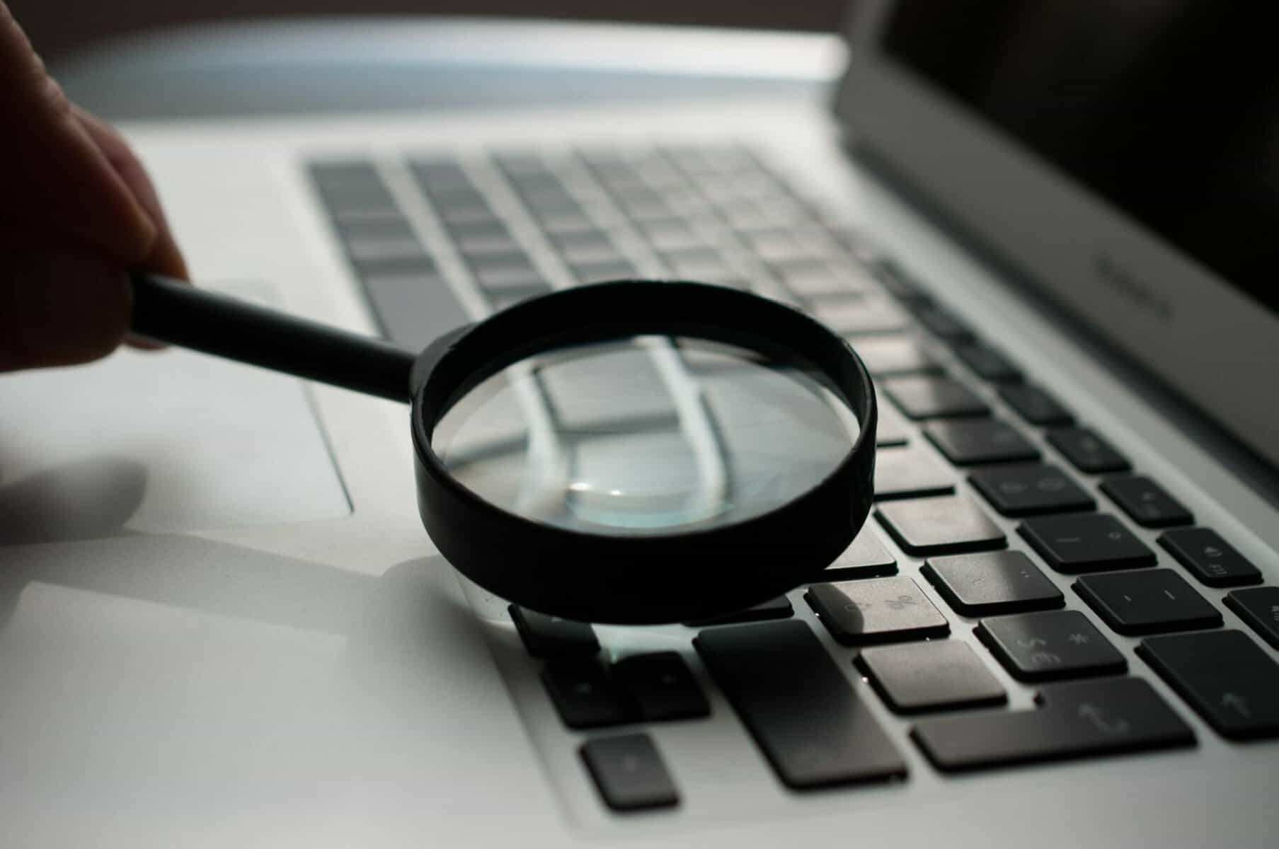 Magnifying glass over laptop keyboard