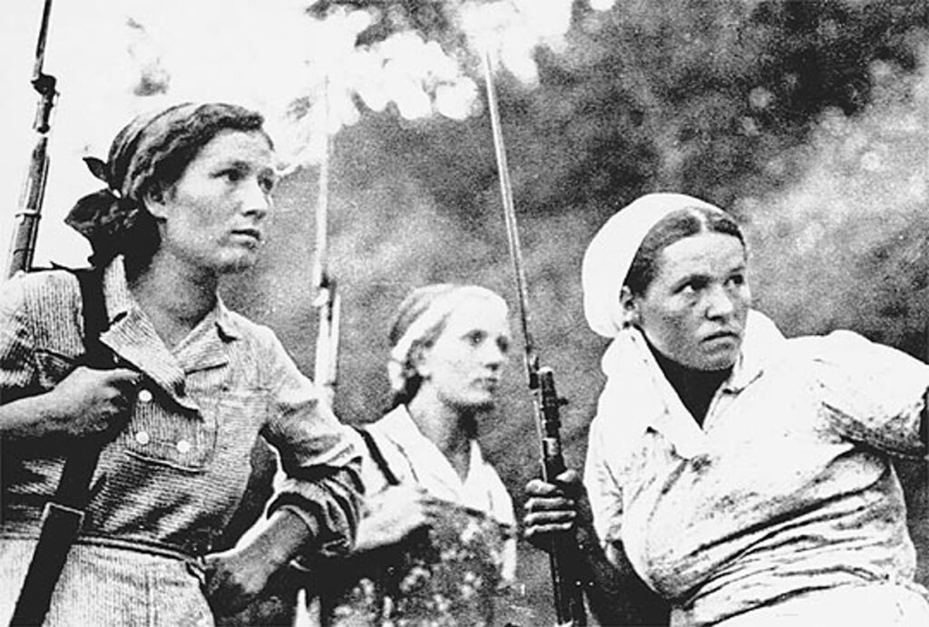 Russian partisans help fight behind German lines - Photo of 3 Soviet women in WWII, holding weapons.