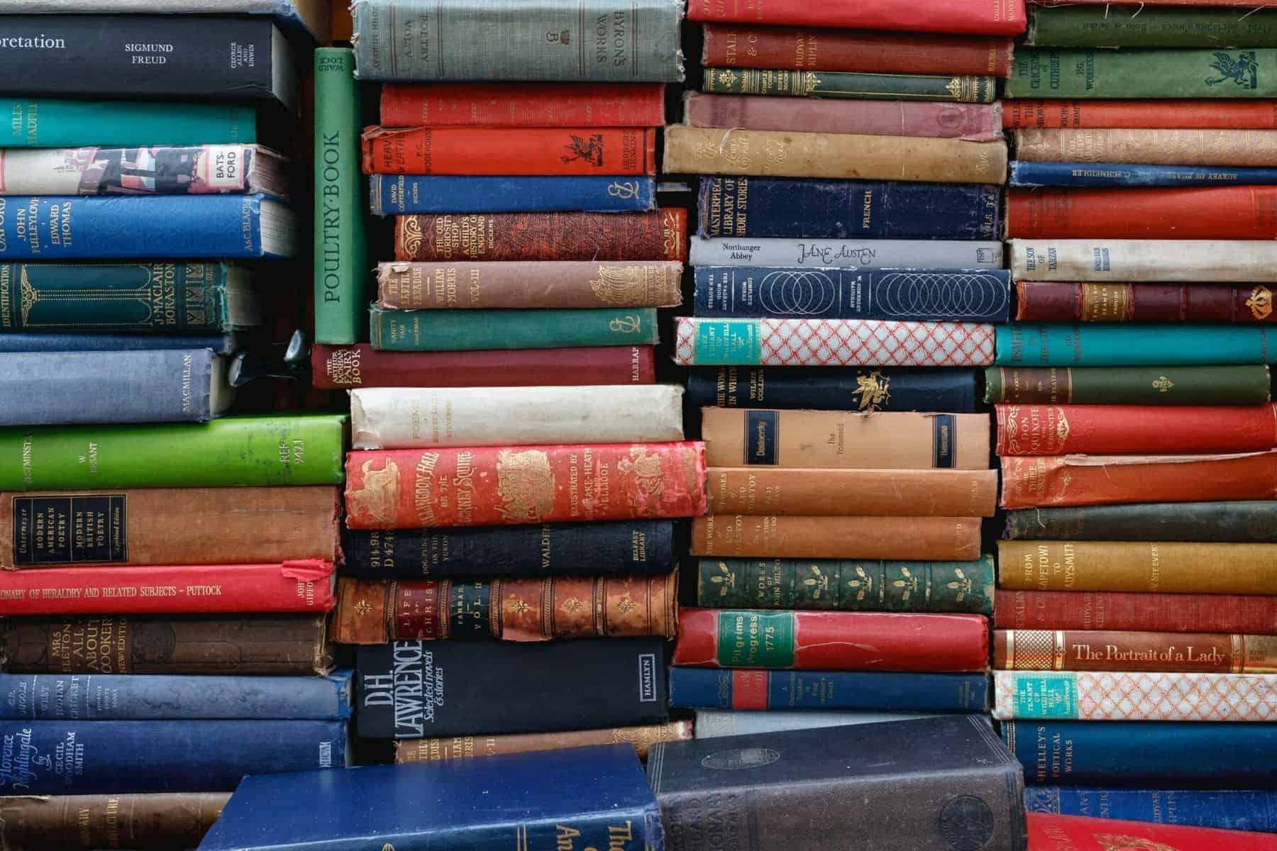 Header image - piles of leather bound books with spines facing outwards