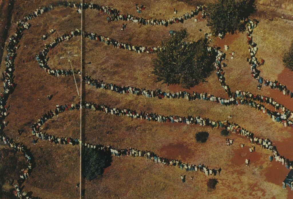 Image shows individuals all stood in lines from above, called, 
